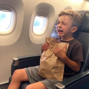 In the airplane restroom, I discovered a weeping young boy holding a paper bag, and he wasn’t listed among the passengers.